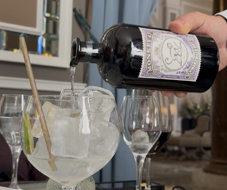 Monkey 47 gin being poured into a large tonic glass
